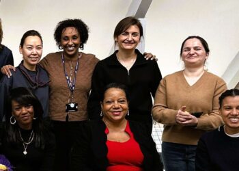 A group of women smile at the camera