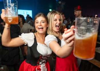 Friends with steins at Oktoberfest on the Common