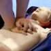 Someone demonstrates CPR on a CPR Manikin