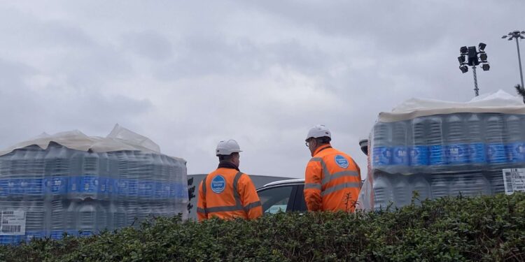 Bottled water piled up at the Thames Water distribution point at Sainsbury's car park in Bell Green. 
CREDIT: Robert Firth