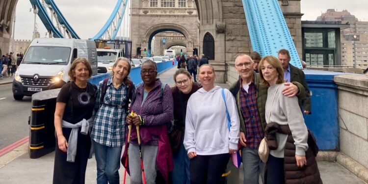 Michael and supporters / staff from the Copleston Centre finishing the 10 mile walk at Tower Bridge. Credit: Michael Holland