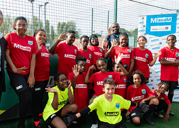 Mike Tomkins, the Chairman of MandM, with footballers at Harris Academy Peckham
