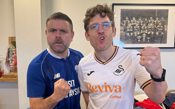 Two men cheer in football kits