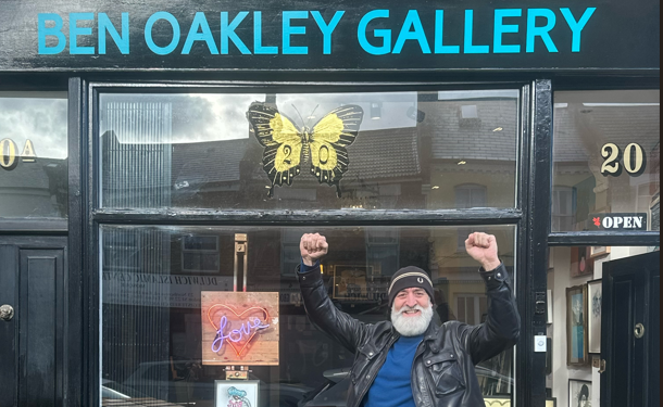 Man celebrates in front to art gallery